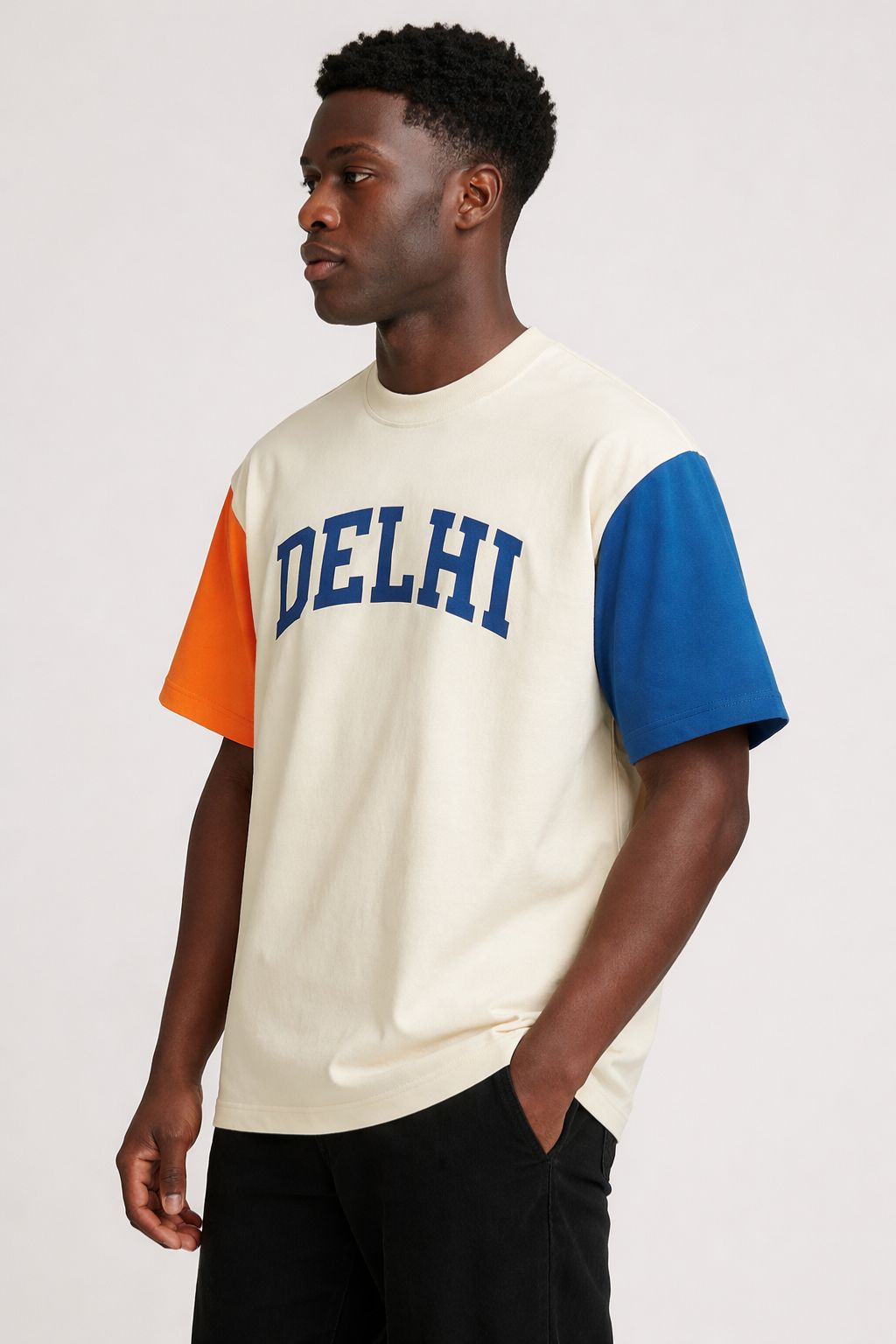 Man wearing a t-shirt with 'DELHI' printed on it against a white background