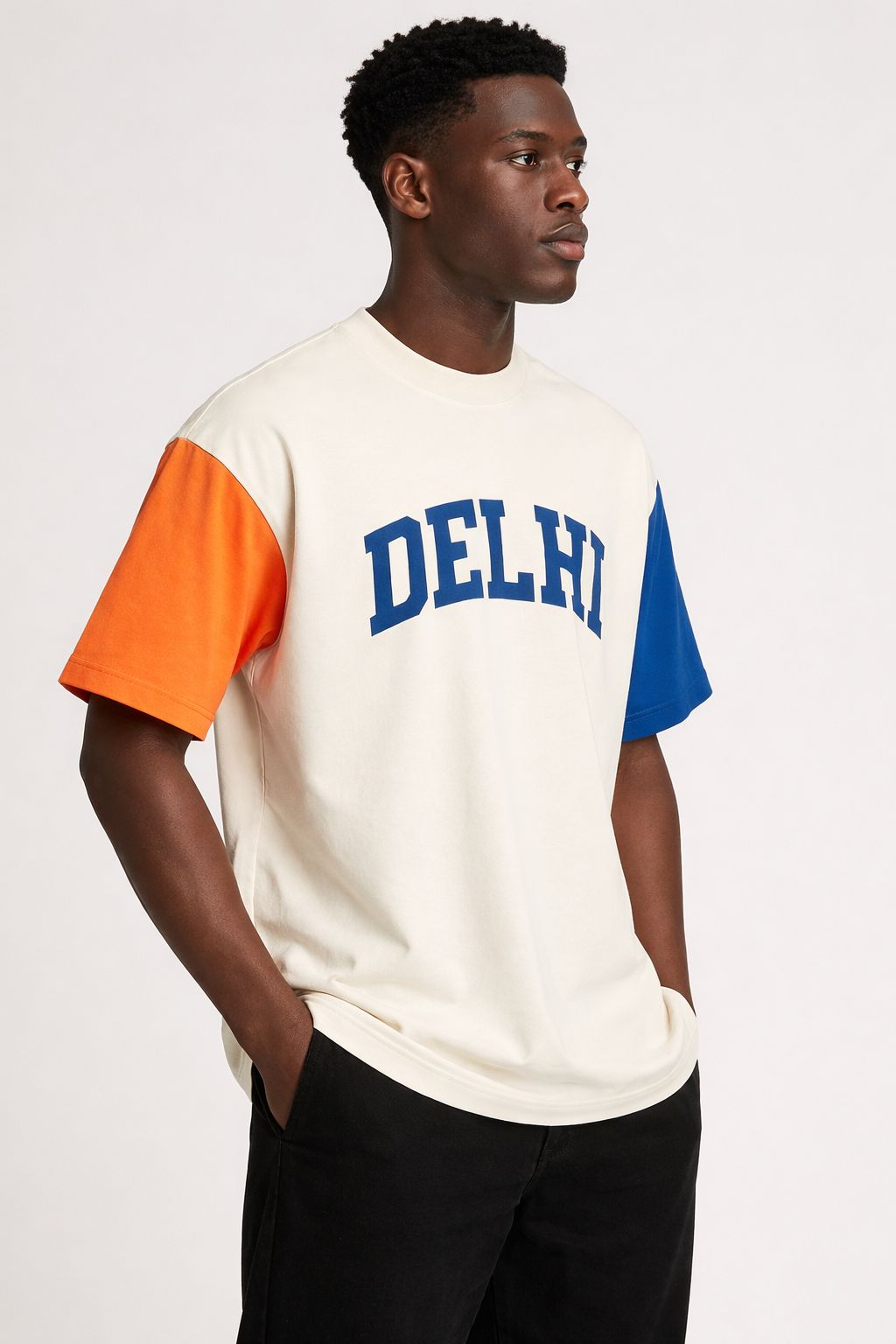 Man wearing a white t-shirt with orange sleeves and blue 'DELHI' print on a white background